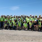 A group of people with bright yellow safety vests at the Species Conservation Habitat Project