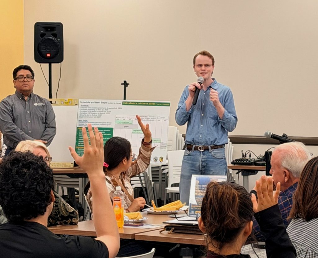 Assistant Secretary for Salton Sea Policy, Joe Shea holding a microphone in front of a group